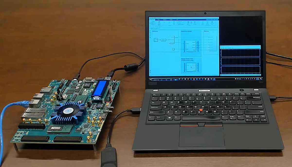 A laptop computer running Simulink connected to an FPGA development board for prototyping an ASIC design.