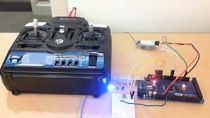 Program an Arduino Mega 2560 using Simulink to receive the signals from an R/C receiver. Relevant Simulink blocks can be downloaded from MATLAB File Exchange.